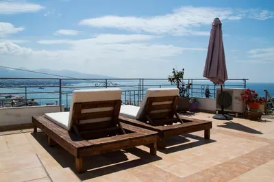 two chairs sitting on a balcony with an umbrella at Piraeus Lux Secret in Piraeus