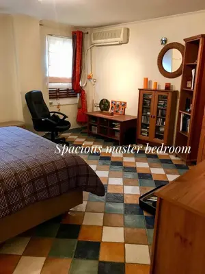 a bedroom with a bed and a desk and a chair at Piraeus Lux Secret in Piraeus