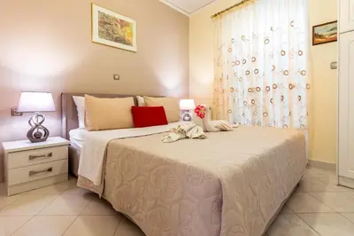 a bedroom with a large bed and a window at Piraeus Lux Secret in Piraeus