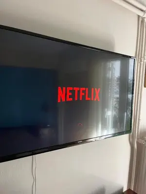 a television with the netflix sign on a wall at Central flat - 2 Metro stops from ACROPOLIS-PLKA in Athens