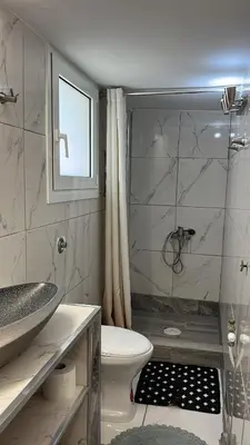 a bathroom with a toilet and a sink and a shower at Central flat - 2 Metro stops from ACROPOLIS-PLKA in Athens