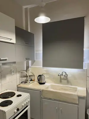 a kitchen with a white stove and a sink at Central flat - 2 Metro stops from ACROPOLIS-PLKA in Athens
