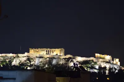a building on top of a mountain at night at Acropolis View Apartment in Central Athens! SQ1 in Athens