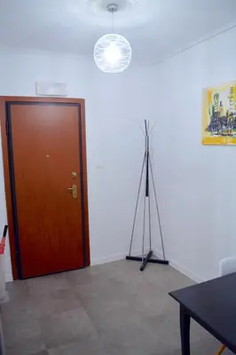 a room with a wooden door and a camera tripod at Acropolis View Apartment in Central Athens! SQ1 in Athens