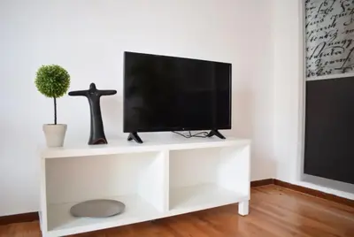 a white entertainment center with a flat screen tv at Acropolis View Apartment in Central Athens! SQ1 in Athens