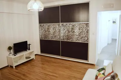 a living room with a tv and a wall at Acropolis View Apartment in Central Athens! SQ1 in Athens
