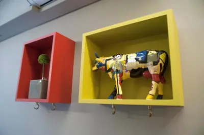 a shelf with a toy cow and a plant in it at Acron of Plaka by YHA in Athens