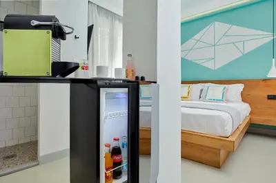 a room with a refrigerator with a bed in it at Mosaikon in Athens