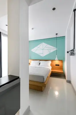 a bedroom with a bed with a blue wall at Mosaikon in Athens