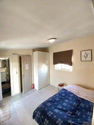 a bedroom with a bed with a blue blanket at Top Floor Apt with Balcony - Acropolis View & Sunset - Koukaki in Athens