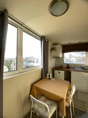 a small kitchen with a table and two chairs at Top Floor Apt with Balcony - Acropolis View & Sunset - Koukaki in Athens