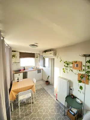 a kitchen and a dining room with a table at Top Floor Apt with Balcony - Acropolis View & Sunset - Koukaki in Athens