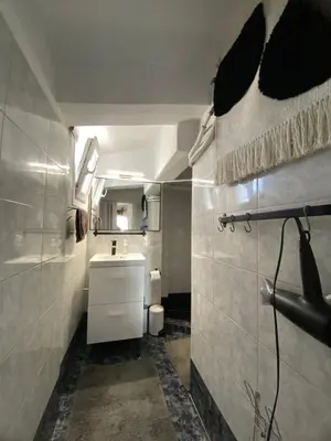 a bathroom with a sink and a toilet in it at Top Floor Apt with Balcony - Acropolis View & Sunset - Koukaki in Athens