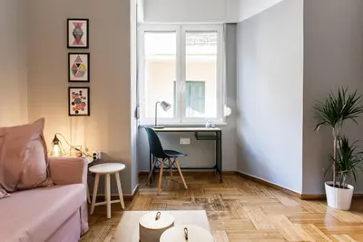 a living room with a couch and a desk at Chic and Cosy Flat in Plaka by UPSTREET in Athens