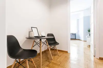 a table and four chairs in a room at Chic and Cosy Flat in Plaka by UPSTREET in Athens