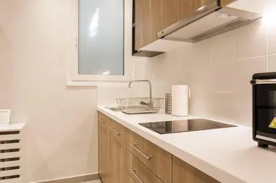 a kitchen with a sink and a stove at Chic and Cosy Flat in Plaka by UPSTREET in Athens