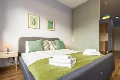a bedroom with a bed with towels on it at Breathtaking View Studio! in Athens