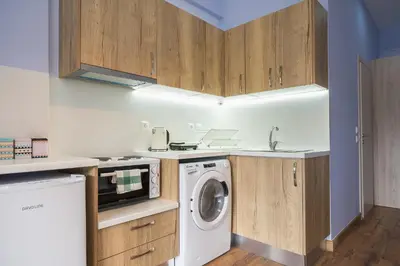 a kitchen with a washing machine and a washer at Breathtaking View Studio! in Athens