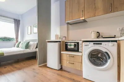a kitchen with a washing machine and a microwave at Breathtaking View Studio! in Athens
