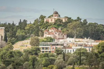 a house on top of a hill with trees at Breathtaking View Studio! in Athens