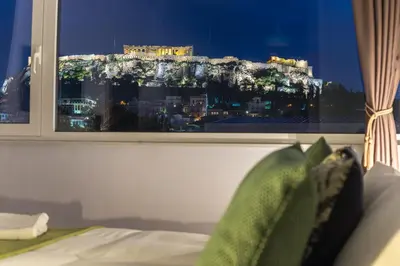 a bedroom with a view of a city from a window at Breathtaking View Studio! in Athens