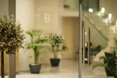 a sign on a glass door with potted plants at B4B Athens Signature Hotel in Athens