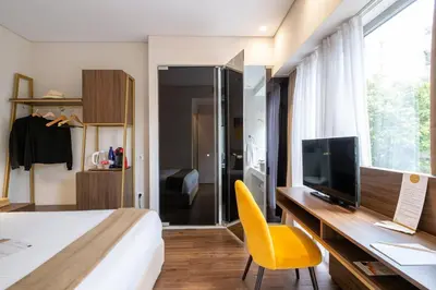 a bedroom with a bed and a desk with a television at B4B Athens Signature Hotel in Athens