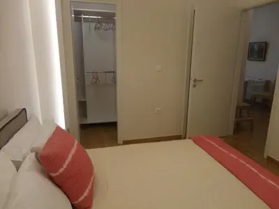 a bedroom with a bed with a red pillow on it at Athenian Center Athens Kolonaki in Athens