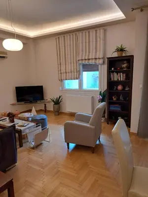 a living room filled with furniture and a tv at Athenian Center Athens Kolonaki in Athens