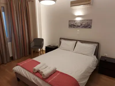 a bedroom with a bed with towels on it at Athenian Center Athens Kolonaki in Athens