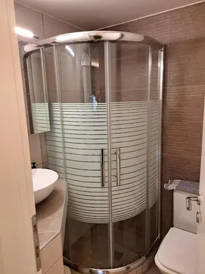 a bathroom with a shower with a toilet and a sink at Athenian Center Athens Kolonaki in Athens