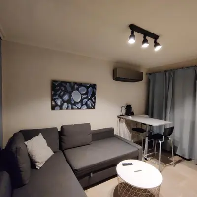 a living room with a couch and a table at Theo's loft in Athens