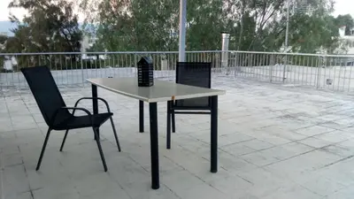 a table and two chairs on a patio at Theo's loft in Athens