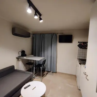 a living room with a couch and a table at Theo's loft in Athens