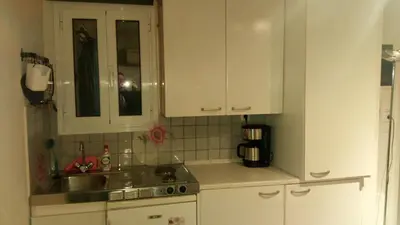 a kitchen with white cabinets and a sink at Theo's loft in Athens