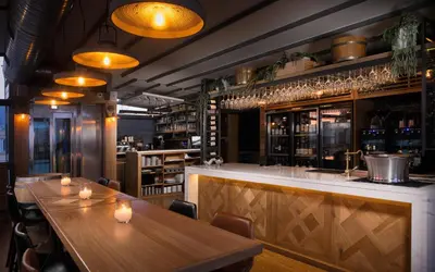 a restaurant with wooden tables and a bar at A for Athens in Athens