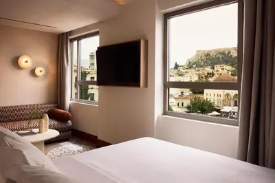 a hotel room with a bed and a large window at A for Athens in Athens