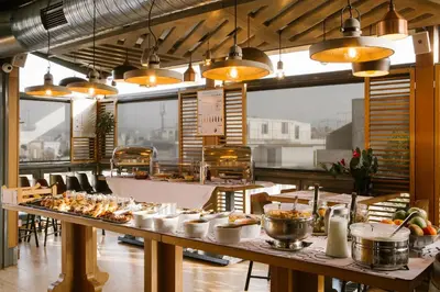 a restaurant with a long table filled with food at A for Athens in Athens