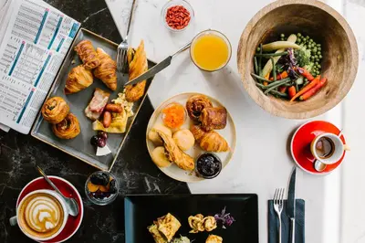 a table with plates of food and a bowl of juice at A for Athens in Athens