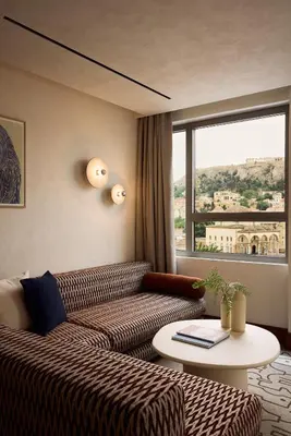 a living room with a couch and a table and a window at A for Athens in Athens