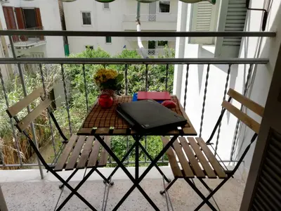 a table and two chairs on a balcony at Wonderful Apartment in central Athens in Athens