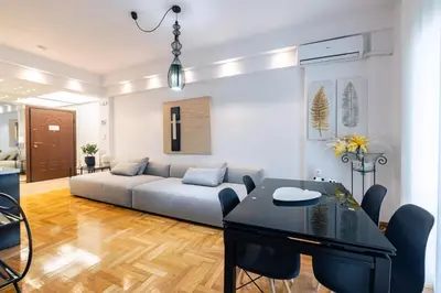 a living room with a couch and a table at Apartment in Glyfada Center in Athens