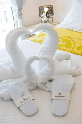 two swans made out of towels on a bed at Apartment in Glyfada Center in Athens