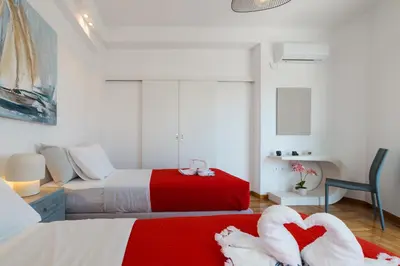a bedroom with two beds with hearts on the floor at Apartment in Glyfada Center in Athens