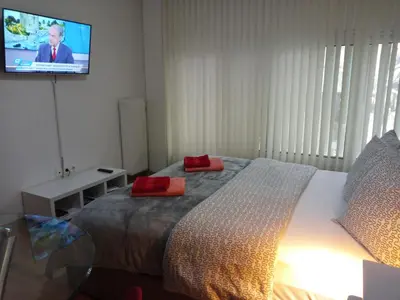 a bedroom with a bed with a tv on the wall at The New Studio Suite Near Akropolis in Athens