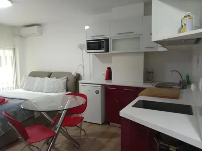 a small kitchen with a table and red chairs at The New Studio Suite Near Akropolis in Athens
