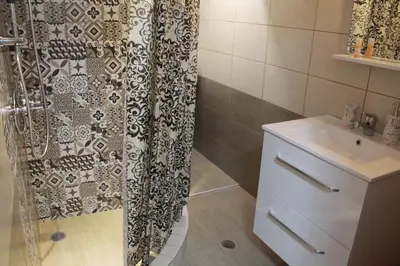 a bathroom with a shower curtain and a sink at The New Studio Suite Near Akropolis in Athens