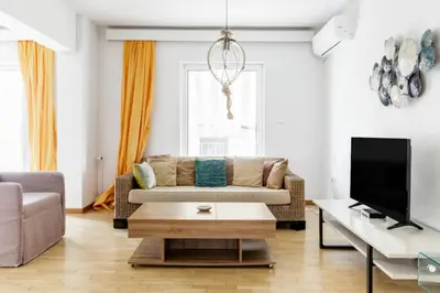 a living room with a couch and a coffee table at A Diamond of 140 m2 in Platonas Ancient Athens in Athens