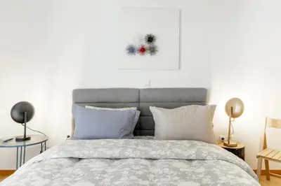 a bedroom with a bed and a picture on the wall at A Diamond of 140 m2 in Platonas Ancient Athens in Athens