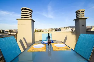 a table and chairs on a balcony with a view at A Diamond of 140 m2 in Platonas Ancient Athens in Athens